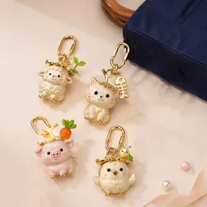 Collection of cute gold-plated animal bag charms with straw hats and enamel details