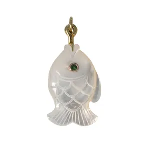 Exquisite hand-carved shell fish pendant with green gemstone eye and gold-toned bale loop