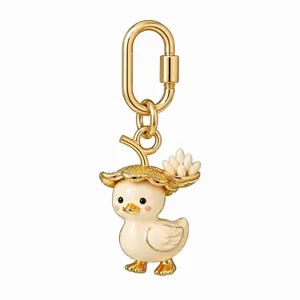 Detail shot of cute gold-plated duckling bag charm with flower hat and carabiner clip.