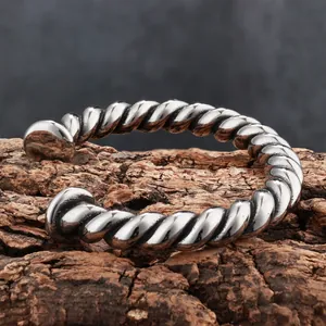 Detailed view of vintage distressed twisted titanium steel cuff bracelet for men