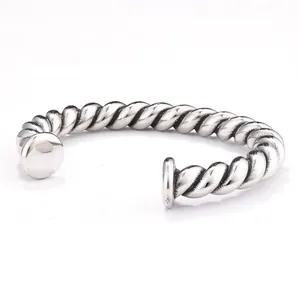 Close-up detail of heavy-duty vintage twisted titanium steel cuff bracelet for men