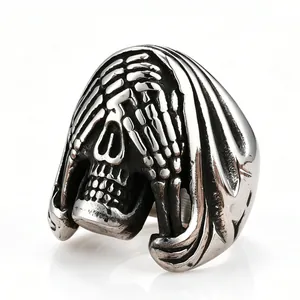 Detailed close-up of a vintage distressed titanium steel skull ring with reaper hood design