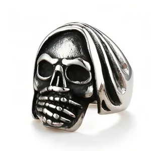 A detailed macro view of a vintage titanium steel skull ring featuring a reaper hood design