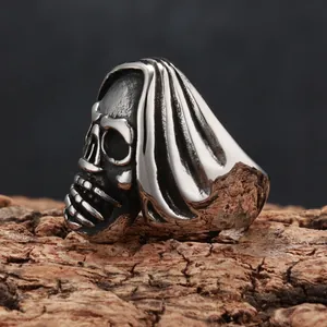 Close-up macro view of a vintage titanium steel grim reaper skull ring with a punk dark finish