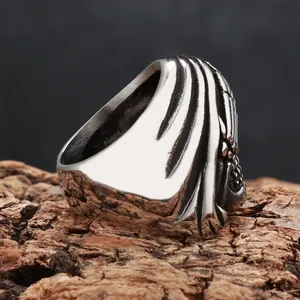 Close-up detail of a vintage distressed skull ring on natural wood bark
