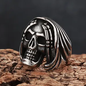 Detailed macro view of a vintage distressed reaper skull ring in dark punk style