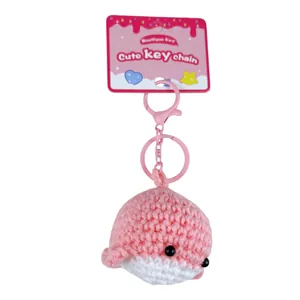 Adorable handmade pink crochet whale keychain with a decorative pink display card