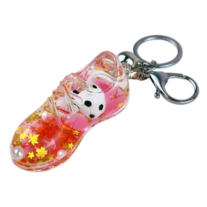 Llavero creativo de bota de fútbol con líquido rosa y estrellas de purpurina brillantes