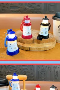 Creative glowing lighthouse keychains in blue, red, and black colors on wood stand.
