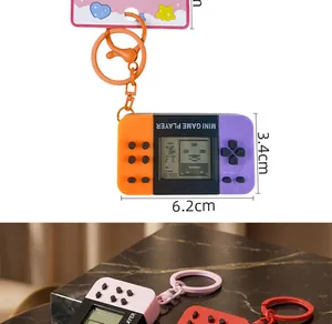 Close-up detail of a retro mini handheld game console keychain showing size dimensions