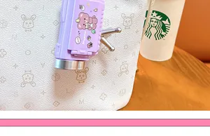 Close-up detail of the purple cartoon animal camera projector keychain with cute bear design