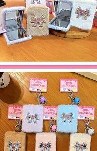 Plush bow-knot folding mirror keychains in various colors with cute boutique packaging cards.