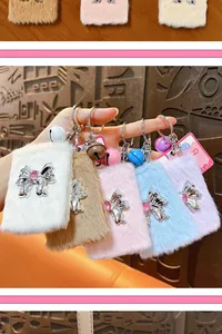 Close-up of assorted plush folding mirror keychains with metallic bows and bells