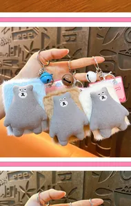 Close-up detail of cute plush bear pocket mirror keychains in blue brown and white