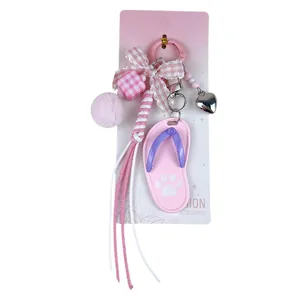 Adorable pink flip-flop bag charm keychain featuring a gingham bow and soft plush ball