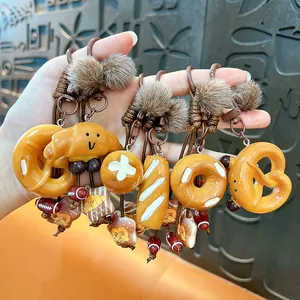 Adorable Maillard style bread keychains set with fluffy brown pom-poms for bags