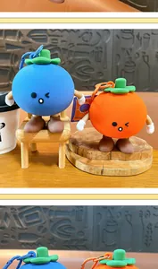 Detailed view of cute fruit-shaped silicone coin storage pouches with lobster clasps