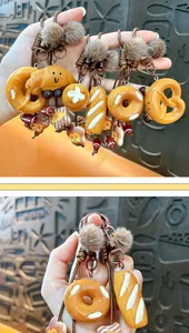 Detailed close-up of cute Maillard style bread keychains with soft plush balls for bags