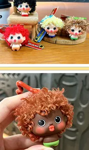 Detailed macro view of cute exploding hair doll keychain with curly brown hair