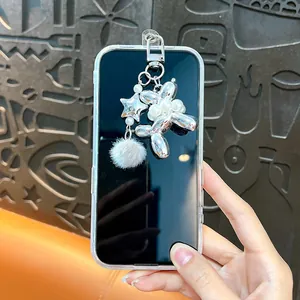 Electroplated silver balloon dog keychain with pearl and fluffy pom-pom charm accessory