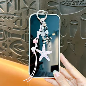 Creative pink acrylic starfish bag charm with glitter effect and silver bow pendant