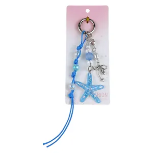 Creative blue acrylic starfish keychain with beaded cord and elegant silver bow charm