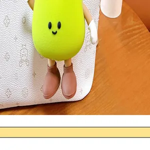 Detailed macro view of the face and small boots on the cute green onion plush keychain