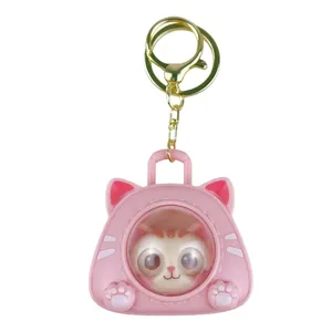 Cute pink cat space capsule keychain featuring a cartoon kitten figure inside for kids.