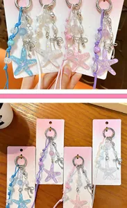 Close-up of colorful acrylic starfish keychains featuring iridescent beads and bow charms