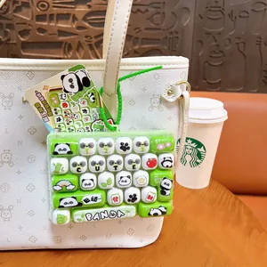 Cute panda mechanical keyboard fidget toy keychain for stress relief on a white bag
