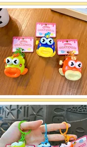 Close-up of colorful wind-up jumping fish keychains with cute big eyes and plastic rings