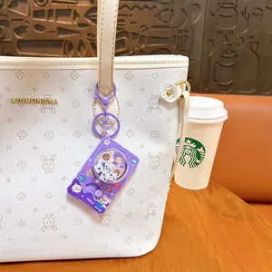Adorable purple cartoon dice machine keychain decompression toy on a white handbag