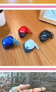 Detail view of creative mini helmet keychains in multiple colors on a wooden table.