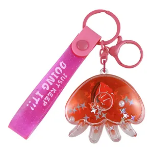 Cute cartoon octopus liquid quicksand keychain featuring a sailboat charm and pink strap