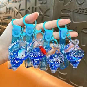 Blue marine series oil-filled shell keychains featuring dolphin and clownfish charms