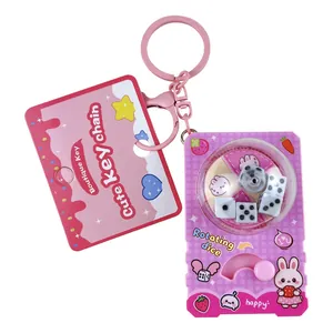 Cute pink cartoon dice machine keychain featuring a rotating stress relief toy design for kids