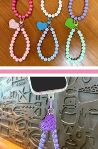 Detail of candy-colored AB beaded phone charm strap with heart-shaped tag and clasp
