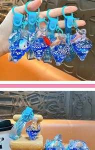 Ocean series shell liquid keychain with floating dolphin and clownfish charm detail