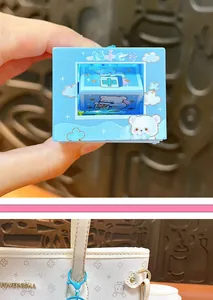 Close-up of a cute blue cartoon flip fidget toy keychain with glowing and sound features