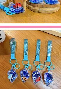 Detailed view of blue seashell-shaped liquid keychains with ocean animal figures