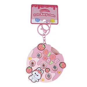 Creative pink press-button dice machine keychain featuring a cute cartoon rabbit design