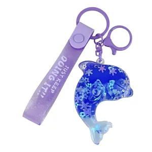 Cute blue dolphin liquid oil quicksand keychain featuring a purple glitter strap pendant
