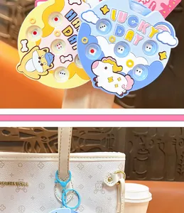 Close-up of cute animal press dice machine keychain charms on a white bag