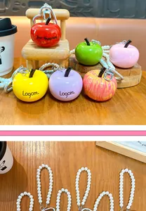 Detailed view of colorful resin apple keychains with elegant pearl-beaded straps.