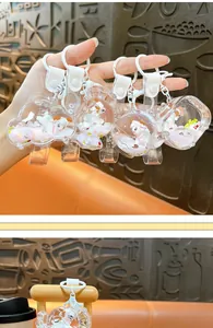 Detailed view of a cute cartoon sheep keychain with flowing liquid sand and glitter.