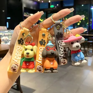 Mano che tiene un set di quattro portachiavi a forma di cane 3D con cinturini Buddy