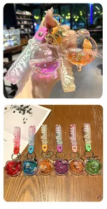Dettaglio di portachiavi con sabbie mobili liquide a forma di sveglia colorati