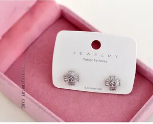 Detailed macro view of white jewelry display cards for 925 silver stud earrings