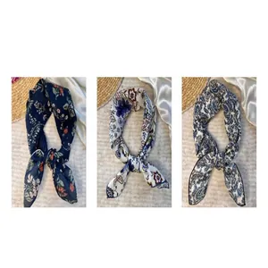 Close-up detail showing three different floral and paisley patterns of cotton square scarves