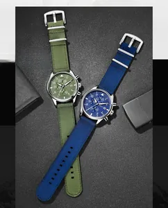 Close-up detail of men's multi-function quartz watches with olive and navy nylon straps